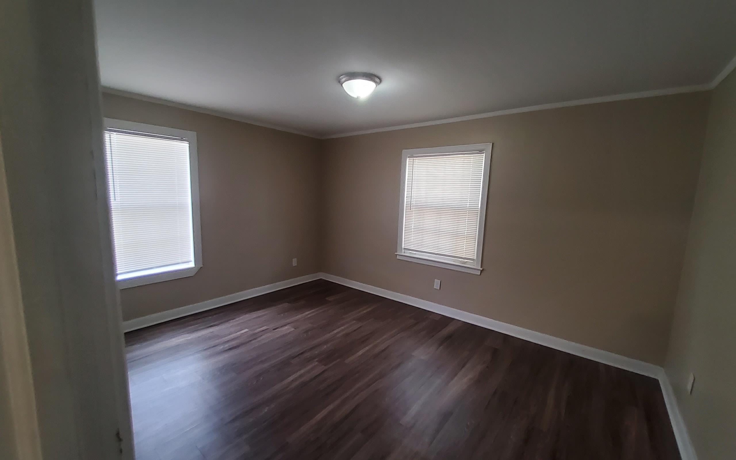 1401 Alamo Street Memphis, TN 38114 - Photo 8 of 11 an empty room with wooden floor and windows