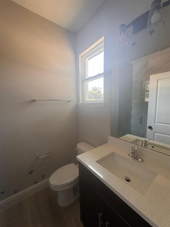 1575 South Montgomery Street DeLand, FL 32720 - Photo 7 of 12 a bathroom with a sink a toilet and a mirror