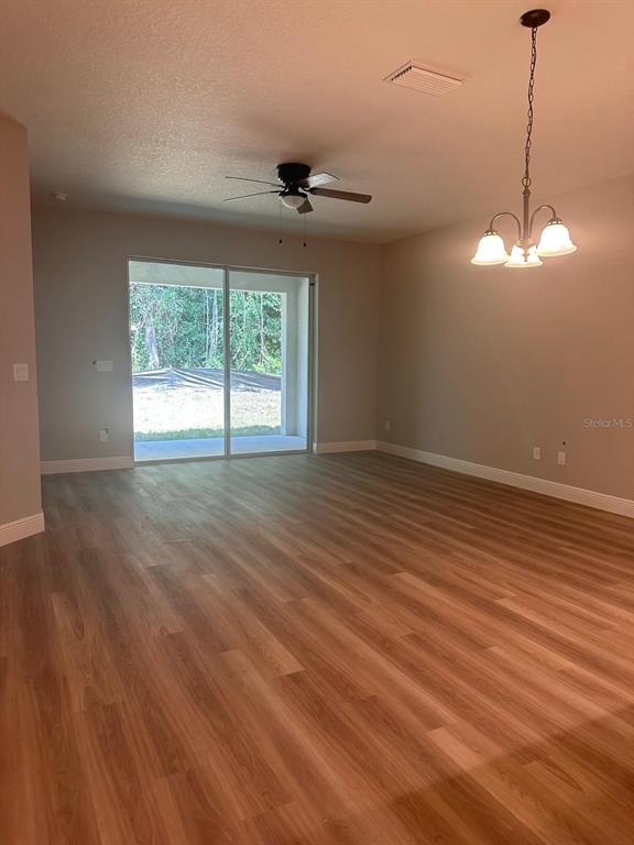 1575 South Montgomery Street DeLand, FL 32720 - Photo 8 of 12 an empty room with wooden floor and windows