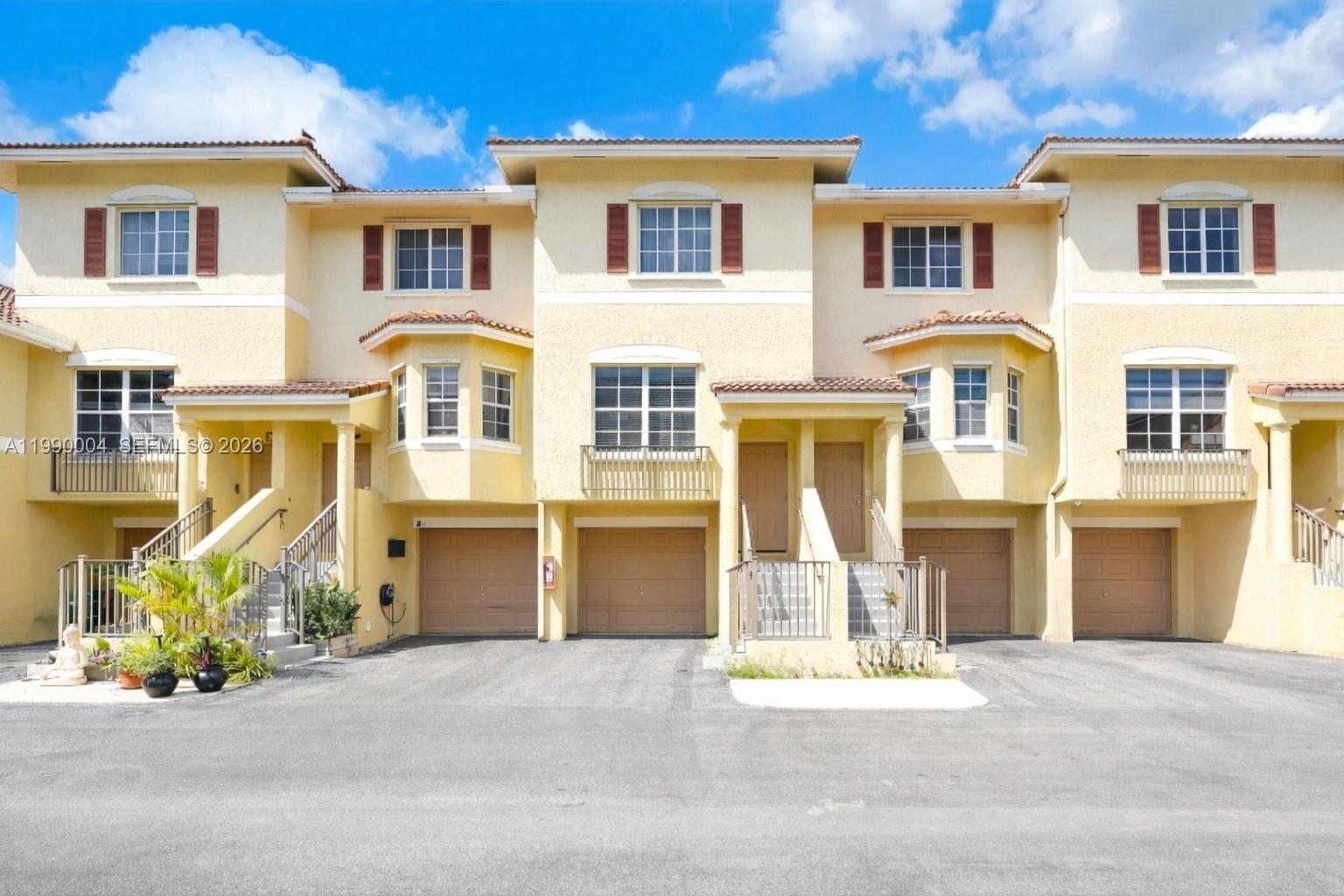 738 Northeast 90th Street, Unit 207 Miami, FL 33138 - Photo 1 of 31 a front view of a house with a garden