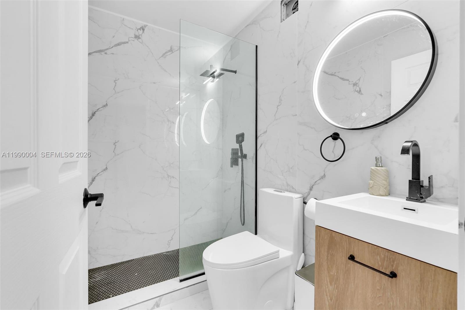 738 Northeast 90th Street, Unit 207 Miami, FL 33138 - Photo 19 of 31 a bathroom with a sink toilet and shower