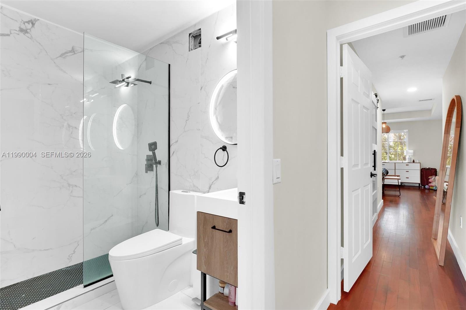 738 Northeast 90th Street, Unit 207 Miami, FL 33138 - Photo 20 of 31 a bathroom with a toilet a sink and shower