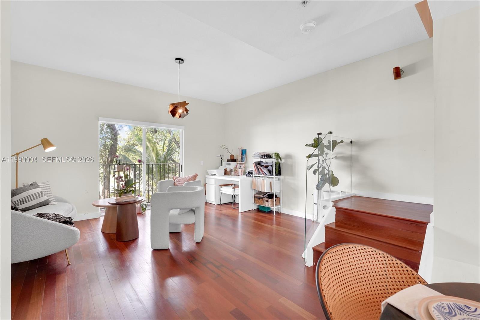 738 Northeast 90th Street, Unit 207 Miami, FL 33138 - Photo 2 of 31 a living room with furniture and a wooden floor