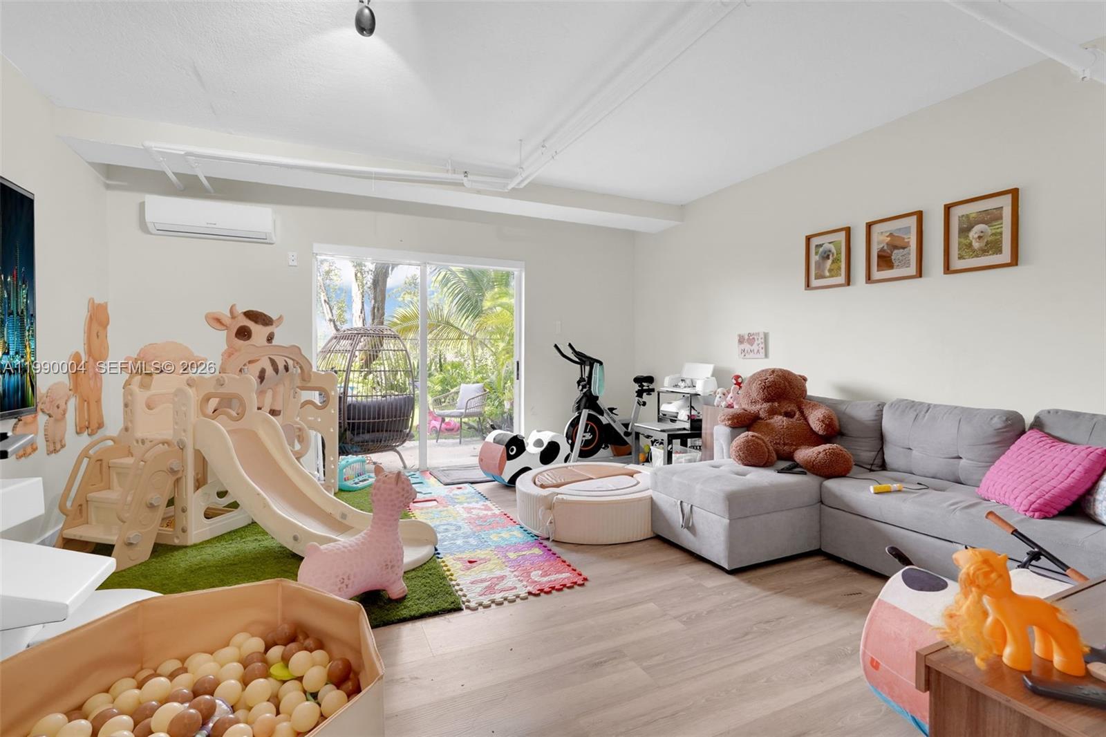738 Northeast 90th Street, Unit 207 Miami, FL 33138 - Photo 21 of 31 a living room with furniture and a large window