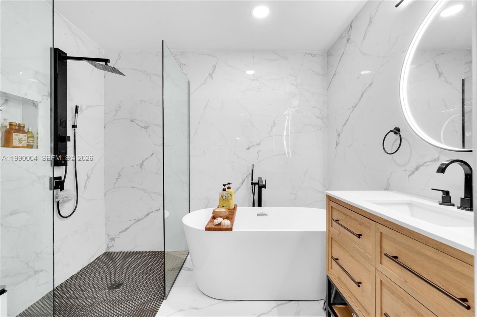 738 Northeast 90th Street, Unit 207 Miami, FL 33138 - Photo 9 of 31 a bathroom with a tub sink and mirror