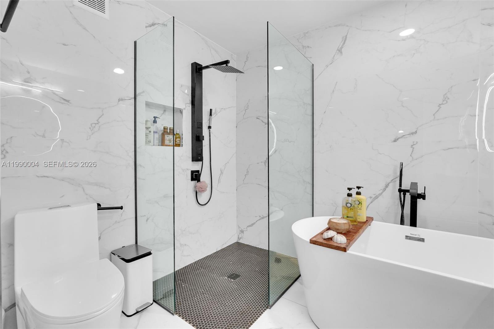 738 Northeast 90th Street, Unit 207 Miami, FL 33138 - Photo 10 of 31 a bathroom with a sink a toilet and shower