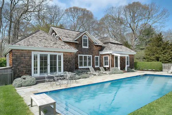 a front view of house with yard seating and green space