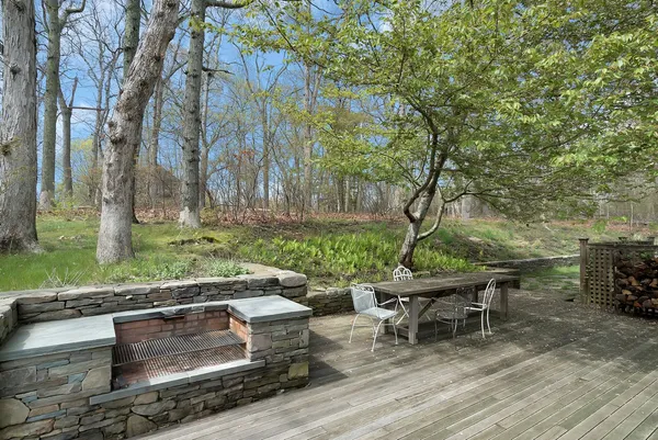 a view of a yard with plants and a bench