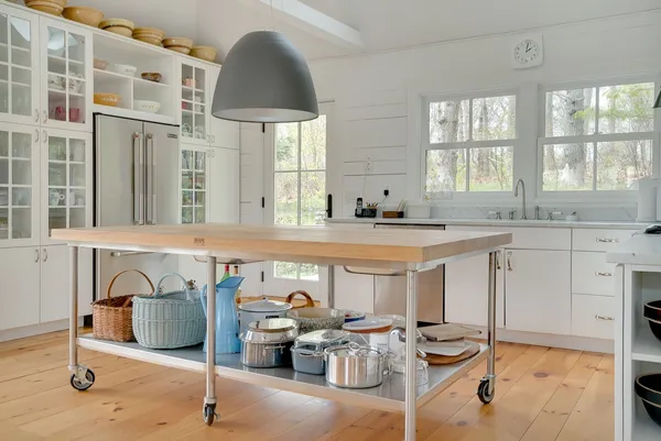 a view of a kitchen with stainless steel appliances kitchen island granite countertop a sink and cabinets