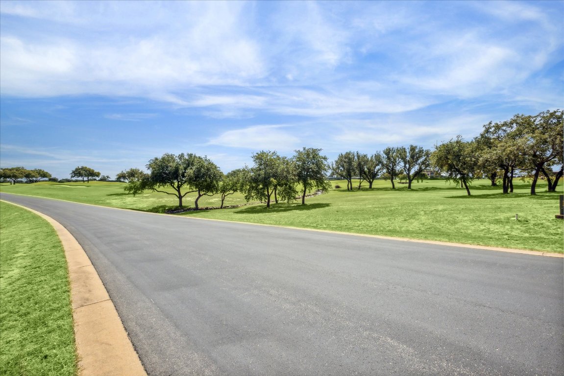 25409 Cliff Crossing Spicewood, TX 78669 - Photo 4 of 11 a view of a golf course with a garden