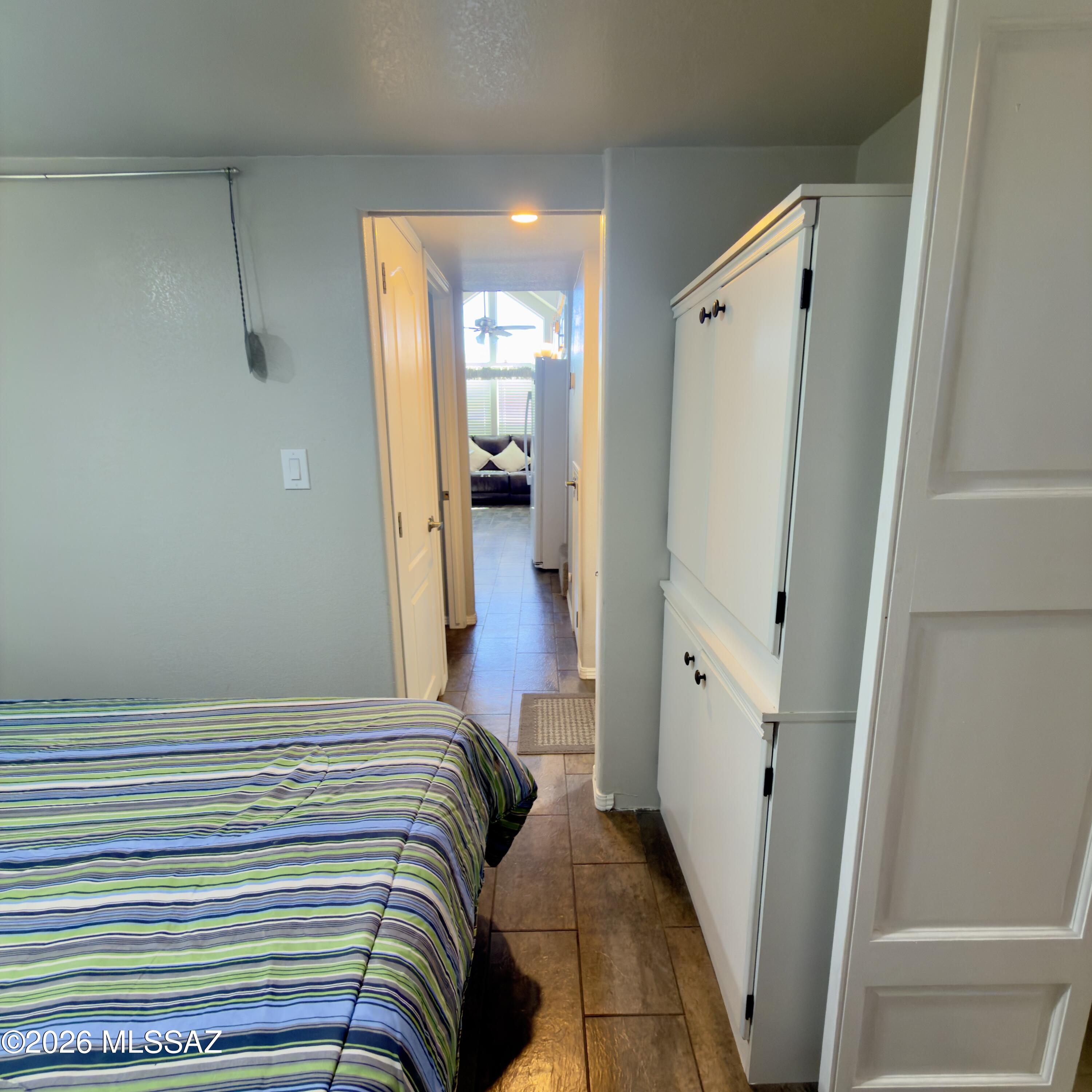 2843 19 Interstate 19 Frontage Road, Unit 116 Amado, AZ 85645 - Photo 19 of 32 a bedroom with a bed and a mirror