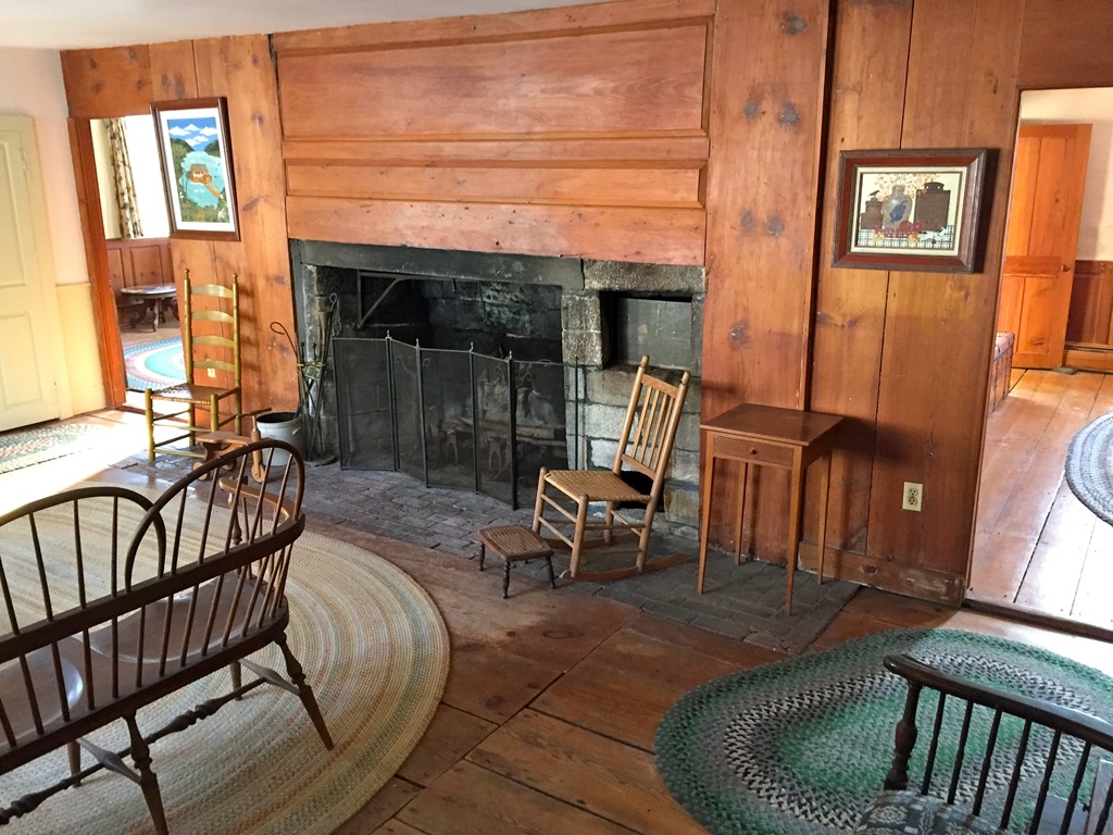 142 Brookfield Road Sturbridge, MA 01518 - Photo 3 of 7 a living room with furniture a fireplace and a floor to ceiling window