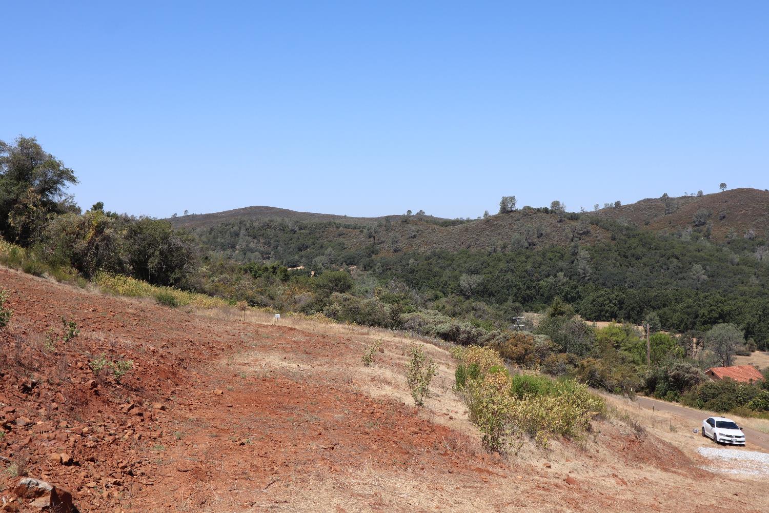 645 Kanaka Valley Road Rescue, CA 95672 - Photo 30 of 47 a view of a dry yard with mountains in the background