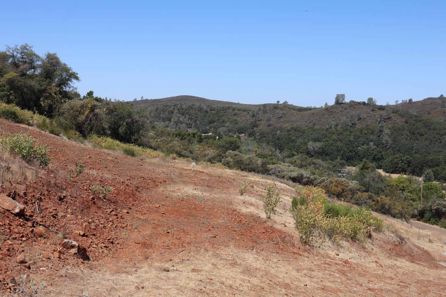 645 Kanaka Valley Road Rescue, CA 95672 - Photo 31 of 47 a view of a dry yard with mountains in the background