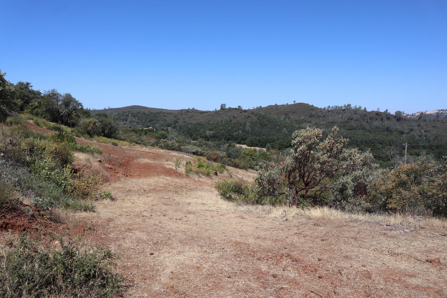 645 Kanaka Valley Road Rescue, CA 95672 - Photo 32 of 47 a view of a dry yard with mountains in the background