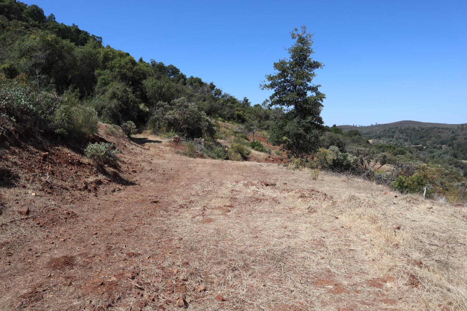 645 Kanaka Valley Road Rescue, CA 95672 - Photo 34 of 47 a view of a dry yard with mountains in the background