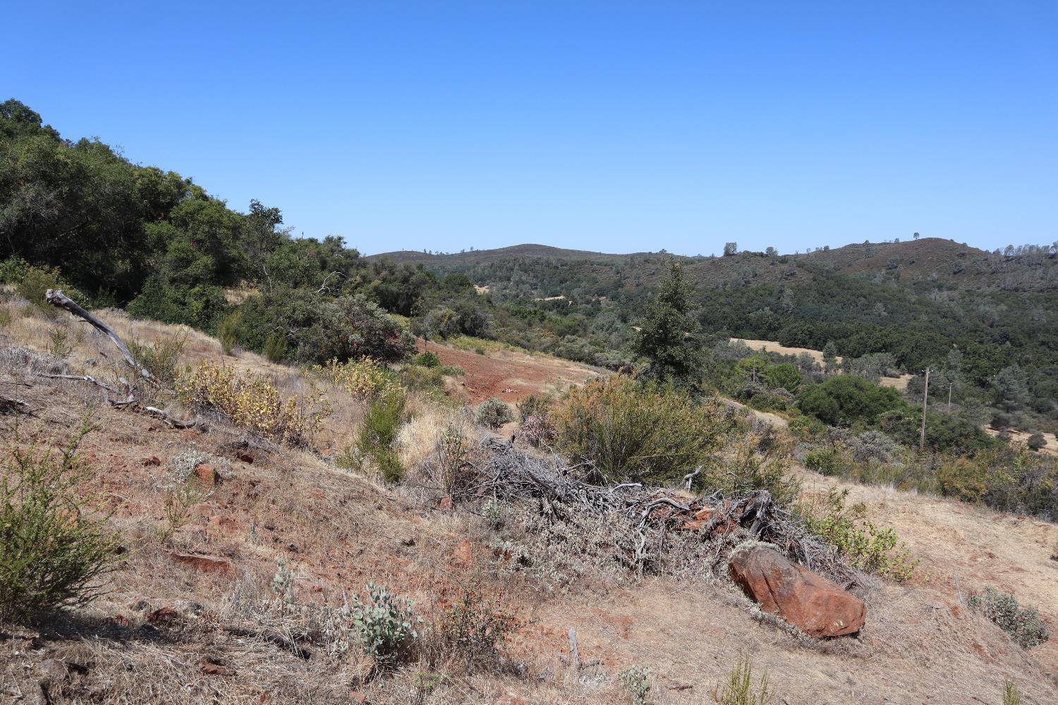 645 Kanaka Valley Road Rescue, CA 95672 - Photo 36 of 47 a view of a dry yard with mountains in the background