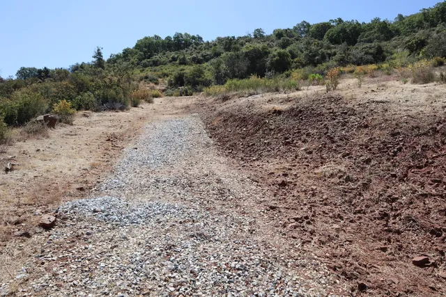 an aerial view of mountain with trees around