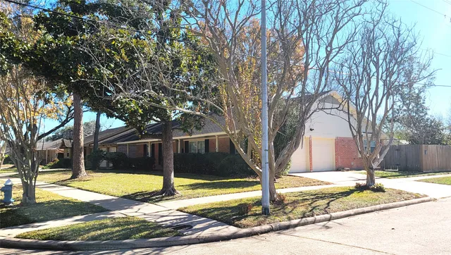 a view of a house with snow on the road