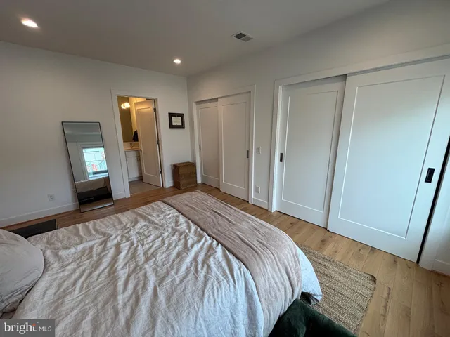 a bedroom with a bed and a mirror