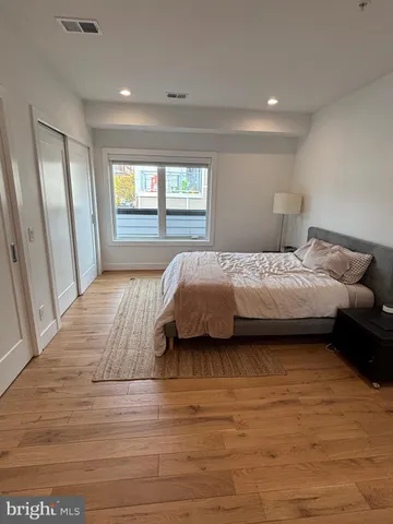 a bedroom with a bed and window