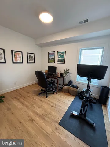 a living room with furniture flat screen tv and a window