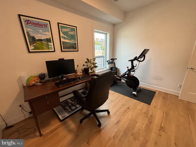 a view of a workspace with furniture and a window