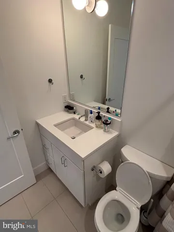 a bathroom with a sink toilet and mirror