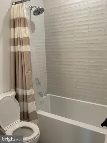 a bathroom with a toilet and a bathtub