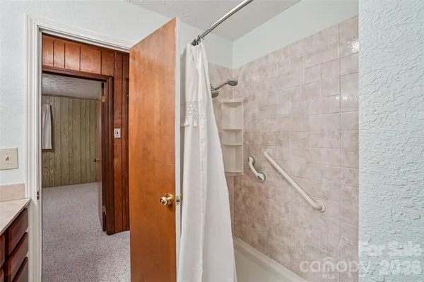 a bathroom with a glass shower door