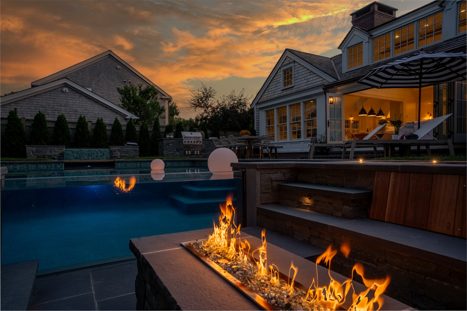 a house view with a sitting space fire pit and outdoor space