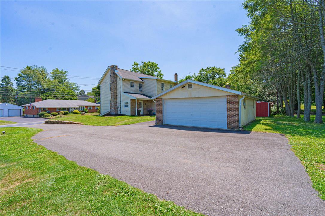 4165 East Texas Road Allentown, PA 18103 - Photo 5 of 56 A classic two-story home with an attached garage and a long asphalt driveway offers ample parking.