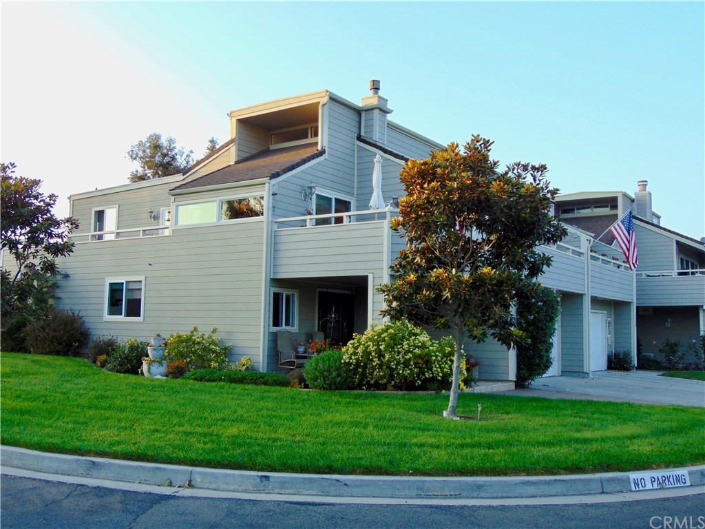 a view of a house with a yard and potted plants