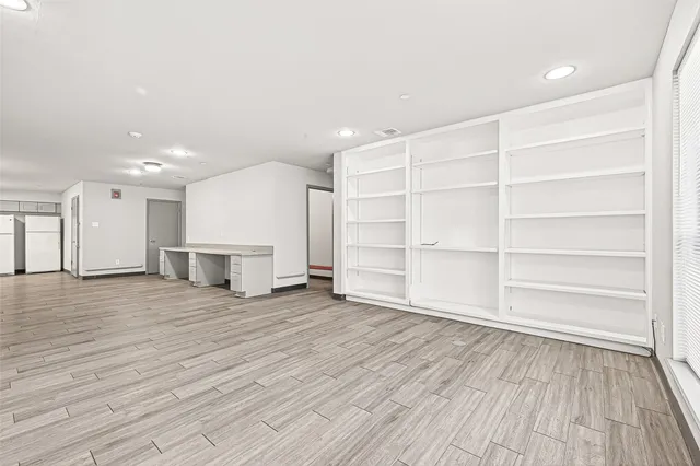 a view of a room with wooden floor and closet