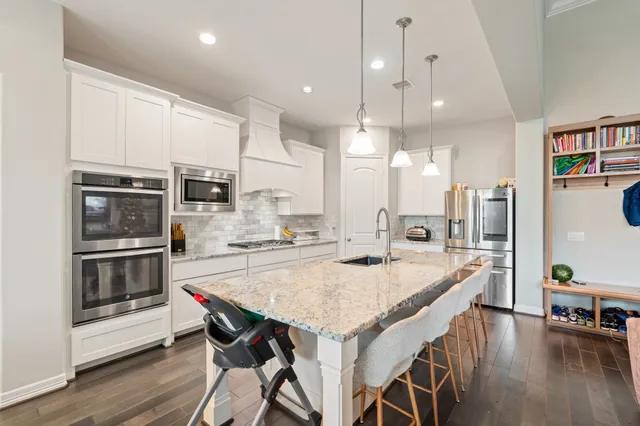 a large kitchen with lots of counter space and refrigerator