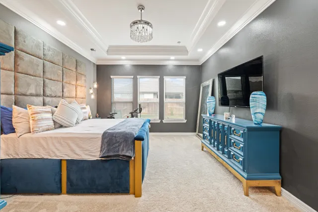 a bedroom with furniture and large windows