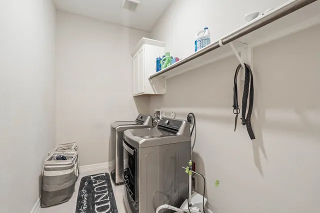 a utility room with sink dryer and washer