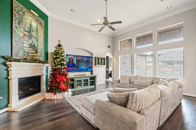 a living room with furniture a fireplace and a flat screen tv