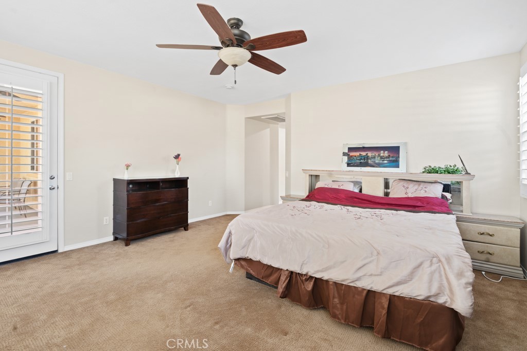 42914 Tomayo Street Indio, CA 92203 - Photo 13 of 31 a bedroom with a bed and a chandelier
