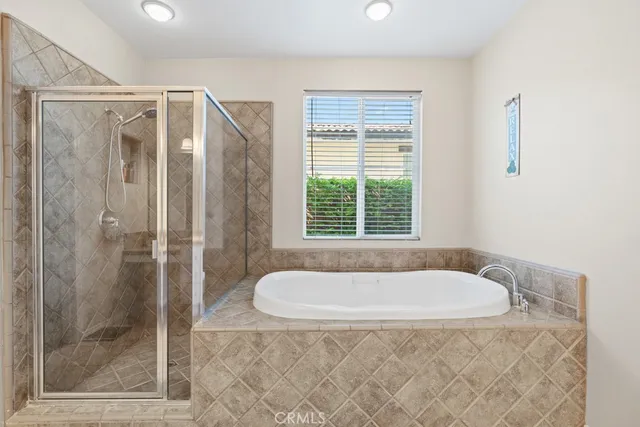 a bathroom with shower and bathtub