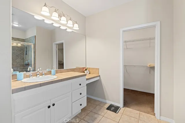 a bathroom with a double vanity sink and a mirror