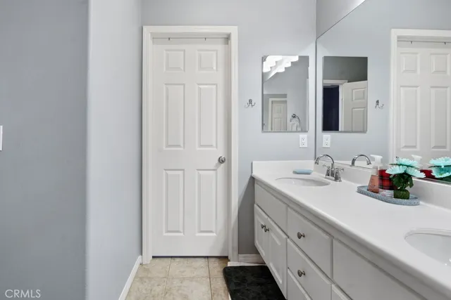 a bathroom with a double vanity sink and a mirror