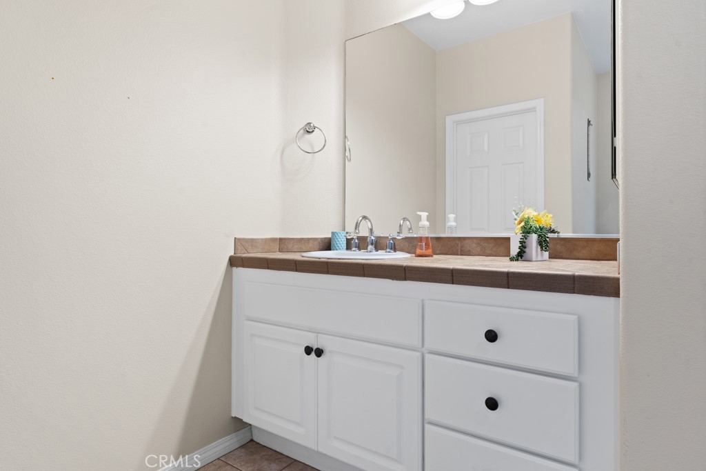 42914 Tomayo Street Indio, CA 92203 - Photo 23 of 31 a bathroom with a sink and a mirror