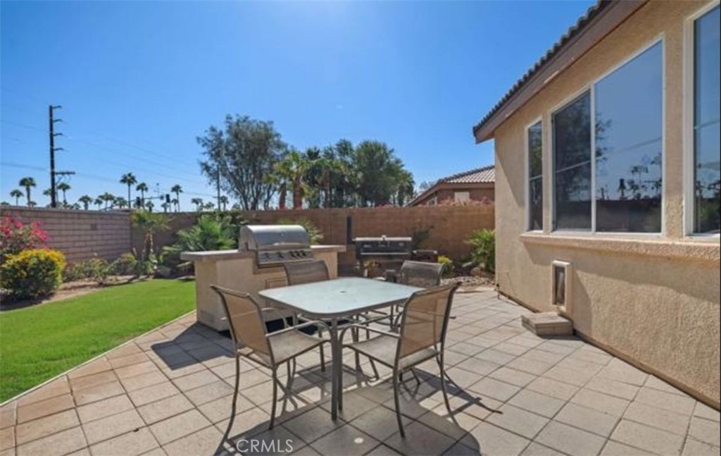 42914 Tomayo Street Indio, CA 92203 - Photo 27 of 31 a view of a patio with a table and chairs