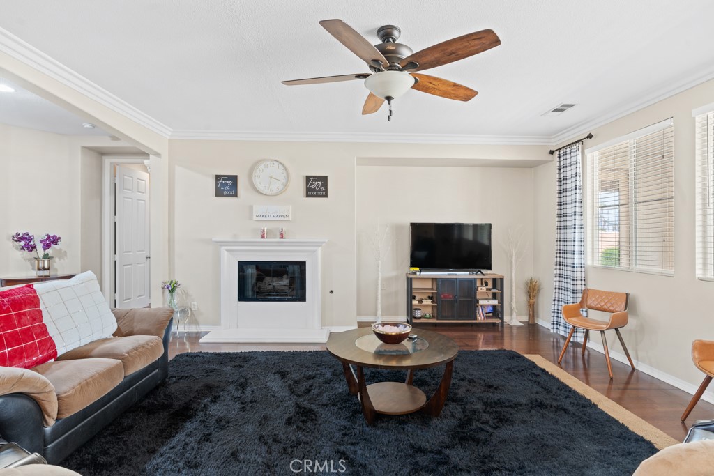 42914 Tomayo Street Indio, CA 92203 - Photo 8 of 31 a living room with furniture a flat screen tv and a fireplace