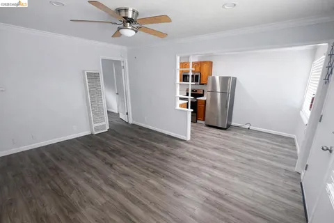 a kitchen with stainless steel appliances a refrigerator and wooden floor