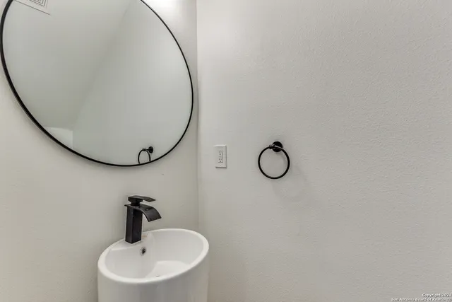 a bathroom with a sink and mirror