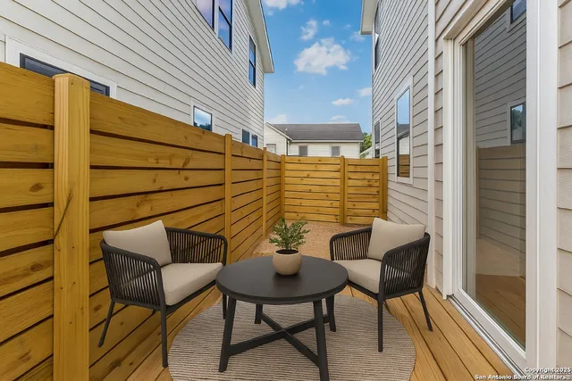 a balcony with table and chairs