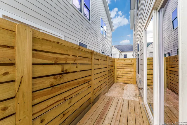 a view of a balcony with wooden floor and door