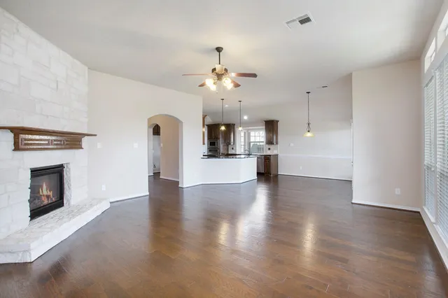 a view of a kitchen with a sink and a fireplace
